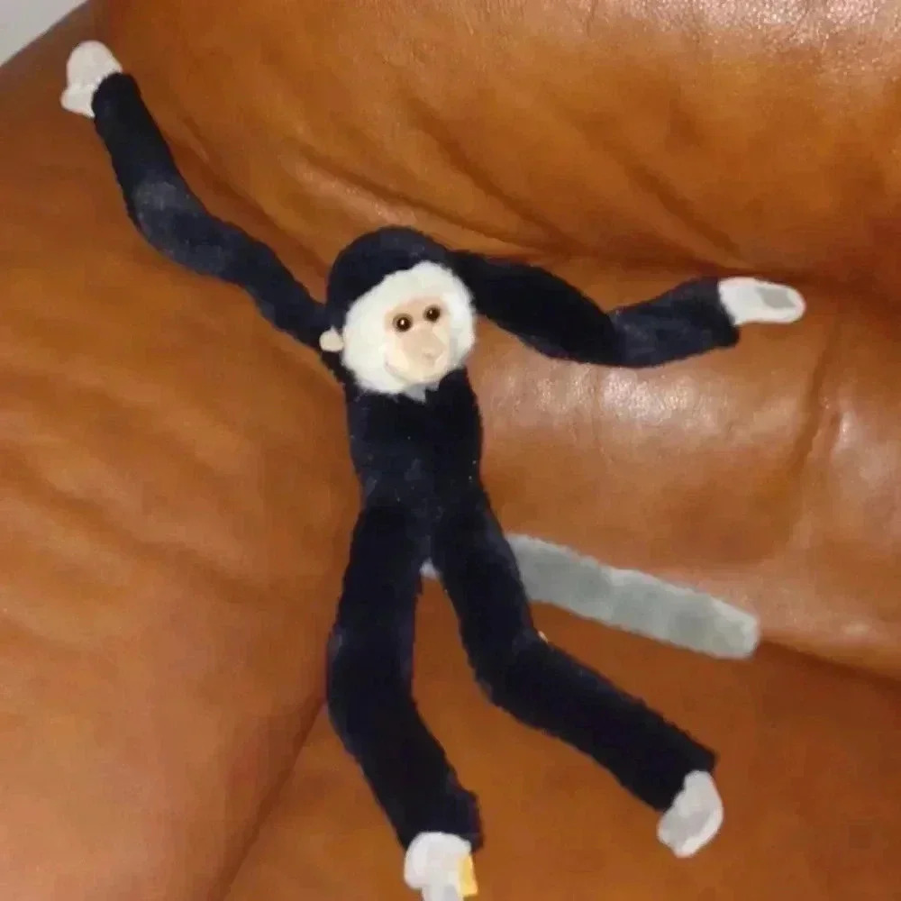 stuffed  monkey with gray tail